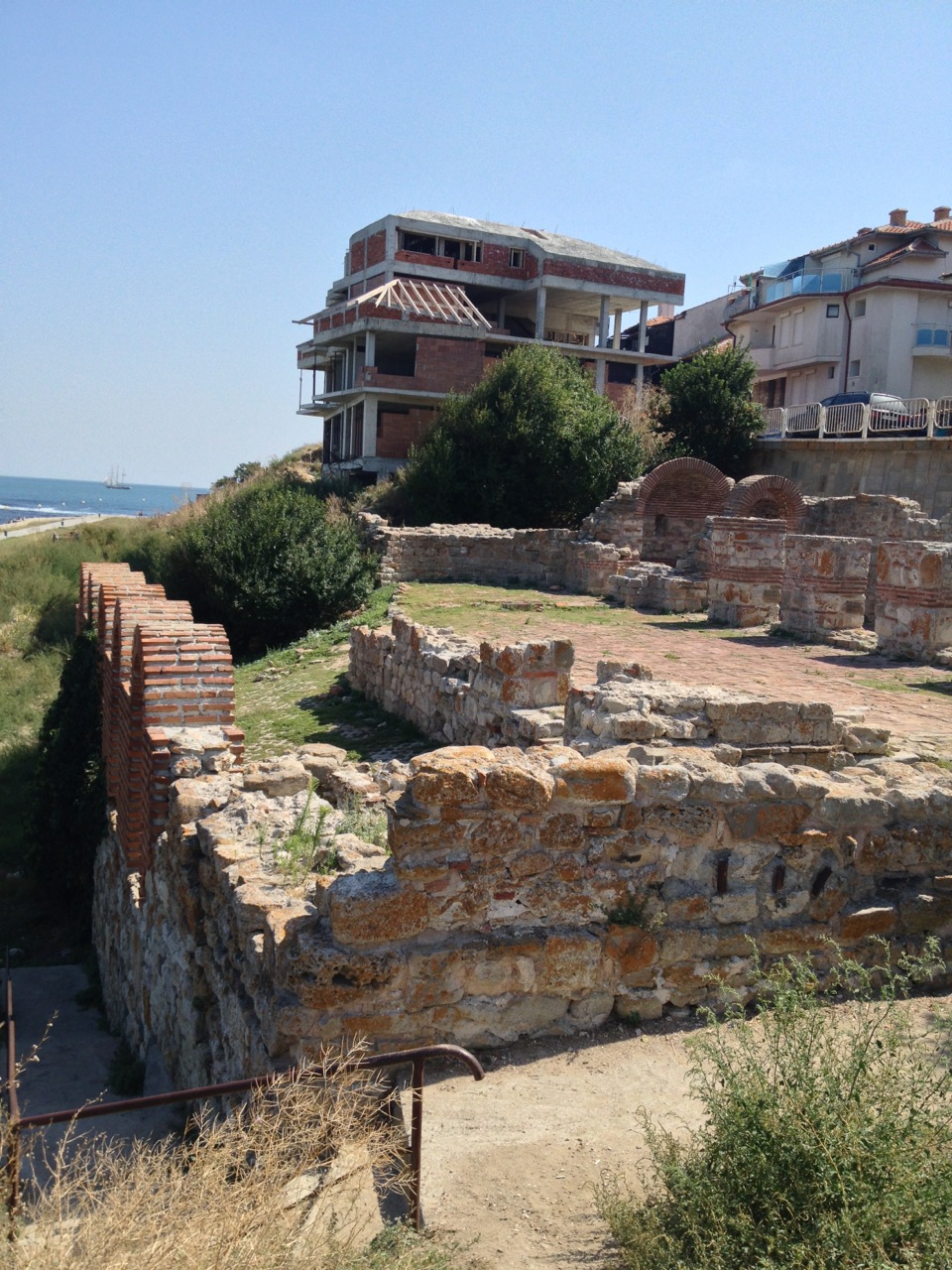 Ancient ruins vs. modern one: an abandoned construction circa 2007 in the background