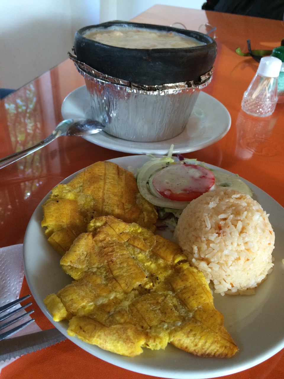 The cazuela de mariscos served with fried plantains